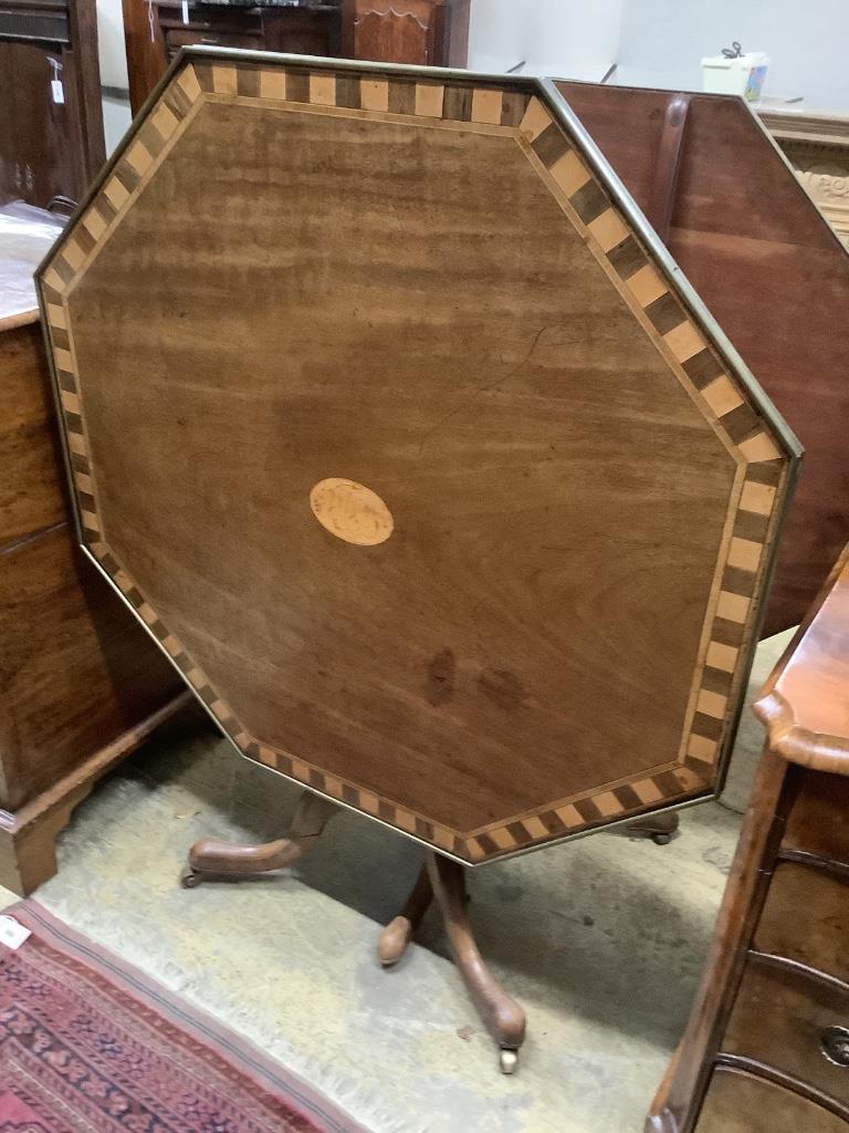 Two similar George III parquetry inlaid mahogany octagonal tilt top tables, width 96cm, height 73cm